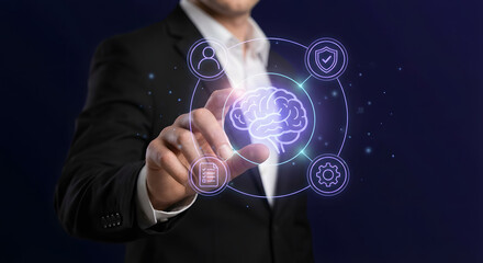 businessman hand touching futuristic digital interface with glowing brain icon and neural network symbols representing artificial intelligence machine learning and cognitive computing