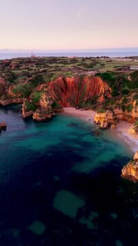 Aerial View of Praia do Camilo Beach at Golden hour in Lagos, Algarve, Portugal. Vertical video