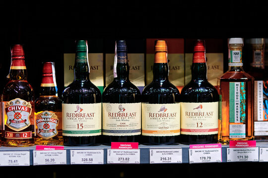 Minsk, Belarus. Dec 29, 2025. Four bottles of Redbreast Irish single pot still whiskey displayed on shop shelf, including Lustau, 15 year old and cask strength editions in premium liquor store setting