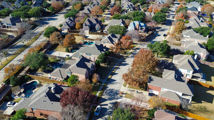 Coppell neighborhood with two-story homes, pools, patios, and clean streets; autumn trees in red, orange, and yellow add warmth to the quiet residential layout and architectural rhythm, Texas