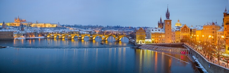 Obraz premium High Resolution Panorama Picture of Winter Snowy Prague Old Town with Prague Castle and Charles Bridge above River Vltava during Sunset , Czech republic