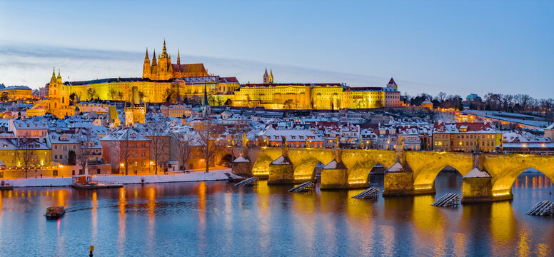High Resolution Panorama Picture of Winter Snowy Prague Old Town with Prague Castle and Charles Bridge above River Vltava during Sunset , Czech republic
