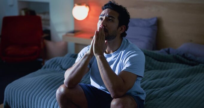Night, thinking and man with depression, bedroom and prayer with insomnia, worry and stress. Evening, home or person with ptsd, sleep disorder or anxiety with mental health, grief and sad memory