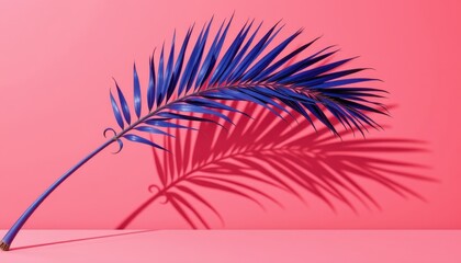 Vibrant Blue Palm Leaf Casting Intriguing Shadows on Pink Backdrop in Modern Artistic Arrangement
