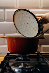 Red pot on gas stove in the kitchen