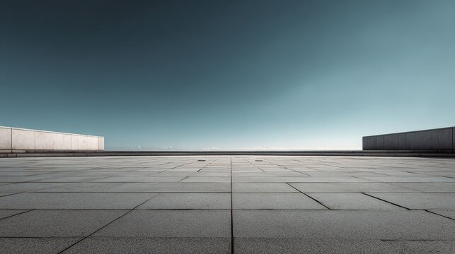 Contemporary empty minimalistic urban square with concrete walls under clear sky.
