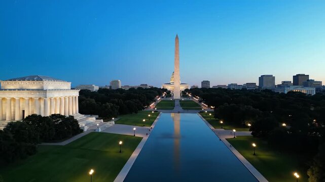 Architectural landscape at dawn featuring reflection pool and monument