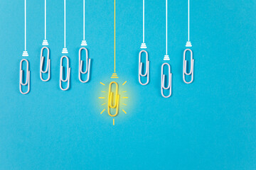 Ideas concept with paperclip as a light bulb	