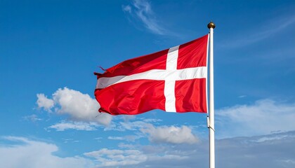 Denmark national flag (Dannebrog) with white Scandinavian cross on red field, flying against blue sky.