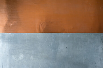 Copper and aluminum metal textures side by side. Neutral left lighting. Copy space.