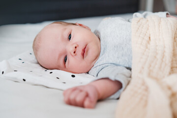 Portrait of 2 weeks old baby. Newborn baby at first months of life.