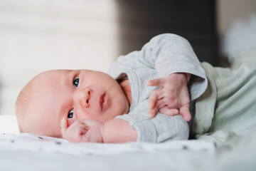 Portrait of 2 weeks old baby. Newborn baby at first months of life.
