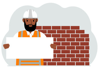 Builder man holding a white sheet of paper for text. Brickwork next to him.