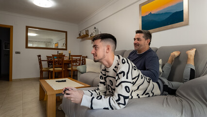 Father and son bonding playing video games together