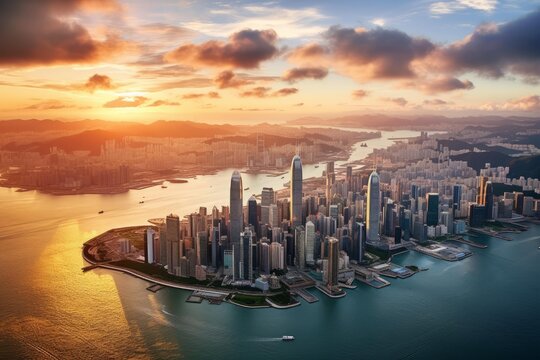 Hong kong central business district and kowloon peninsula skyline during sunset over victoria harbour
