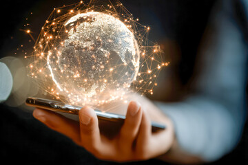 Hand holding smartphone with glowing digital globe and interconnected network points symbolizing global communication and futuristic technology concepts