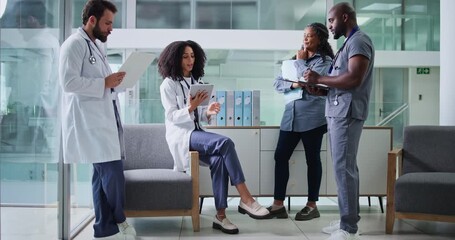 Tablet, meeting and group of doctors in hospital for collaboration on medical diagnosis. Conversation, digital tech and team of professional healthcare people with patient records in medicare clinic - Powered by Adobe