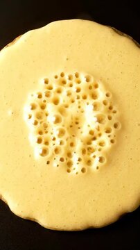 Preparation of a yellow dessert with a smooth topping in a kitchen setting at home