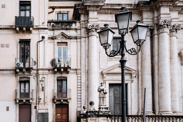 Church Of San Camillo Ai Crociferi In Catania, Sicily: Historic Baroque Church Facade With Twin Bell Towers And Stone Architecture Under Cloudy Sky