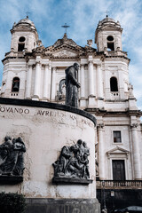 Church Of San Camillo Ai Crociferi In Catania, Sicily: Historic Baroque Church Facade With Twin Bell Towers And Stone Architecture Under Cloudy Sky