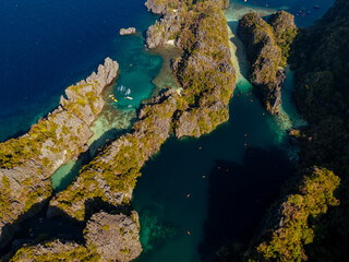 Crystal-clear turquoise water surrounded by dramatic limestone cliffs in the Big and Small Lagoons of Palawan