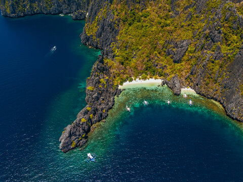 aerial view of El Nido, Philippines, featuring emerald lagoons, limestone karst islands, and vibrant tropical waters