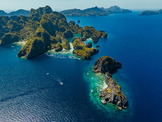 Crystal-clear turquoise water surrounded by dramatic limestone cliffs in the Big and Small Lagoons of Palawan