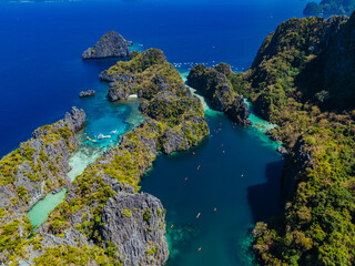 Crystal-clear turquoise water surrounded by dramatic limestone cliffs in the Big and Small Lagoons of Palawan