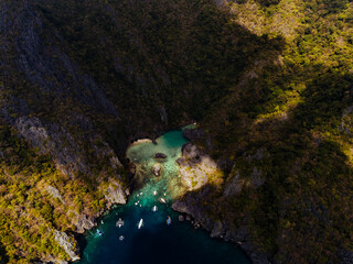 Crystal-clear turquoise water surrounded by dramatic limestone cliffs in the Big and Small Lagoons of Palawan
