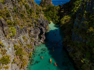 Crystal-clear turquoise water surrounded by dramatic limestone cliffs in the Big and Small Lagoons of Palawan