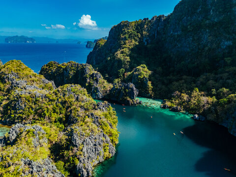 Crystal-clear turquoise water surrounded by dramatic limestone cliffs in the Big and Small Lagoons of Palawan