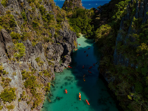 Crystal-clear turquoise water surrounded by dramatic limestone cliffs in the Big and Small Lagoons of Palawan