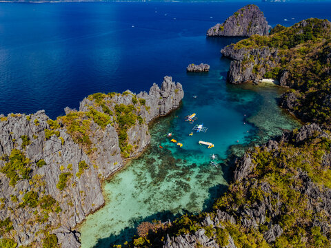 Crystal-clear turquoise water surrounded by dramatic limestone cliffs in the Big and Small Lagoons of Palawan