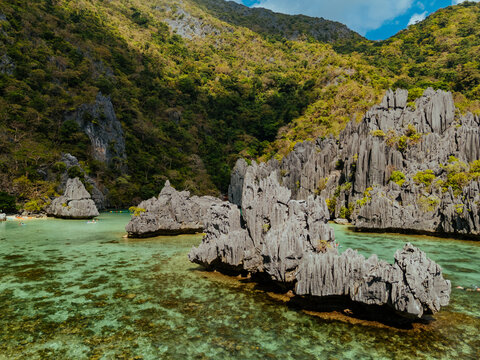 Crystal-clear turquoise water surrounded by dramatic limestone cliffs in the Big and Small Lagoons of Palawan