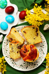 Traditional  Easter pastry kraffin with cottage cheese and raisin on Easter background and painted eggs.