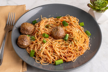 angel hair pasta with green onions and meatballs