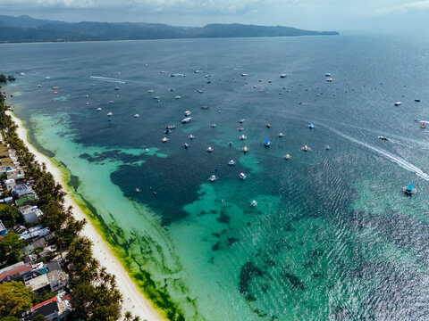 Breathtaking aerial view of Boracay, Philippines, featuring emerald lagoons, limestone karst islands, and vibrant tropical waters