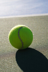 TENNIS CONCEPT. Vertical tennis ball backdrop next to the court. Copy space for logo text or publication.