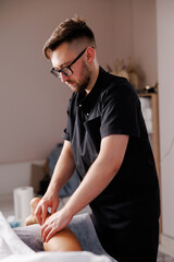 Physiotherapist performing leg massage for muscle recovery