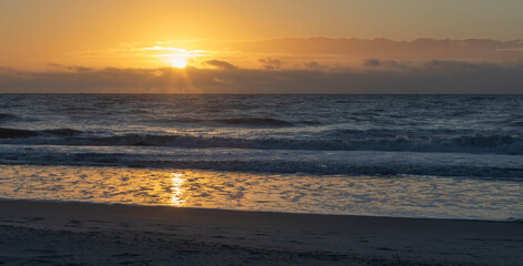 Bright sun low on the horizon over the Atlantic