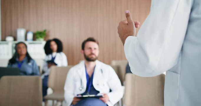 Hands, speaker or doctors with medical workshop in conference room, surgical training or talking. Listen, healthcare seminar or presenter with description of surgery steps, people or lecture speech