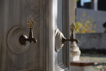 Bronze fountain on marble stone at the mosque fountain