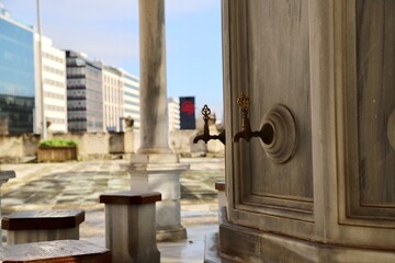Bronze fountain on marble stone at the mosque fountain