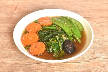 fried mixed vegetable dressing sesame oil and soy sauce with chop garlic on plate