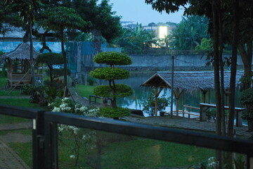 Peaceful Garden Park With Lake And Traditional Gazebo At Dusk