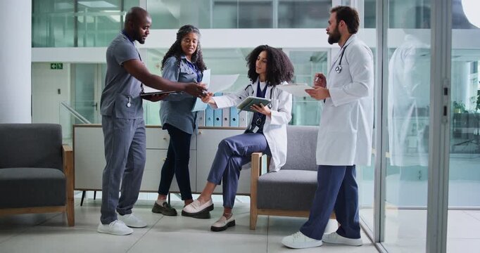 Tablet, discussion and group of doctors in hospital for collaboration on medical diagnosis. Conversation, tech and team of professional healthcare people with patient records in medicare clinic