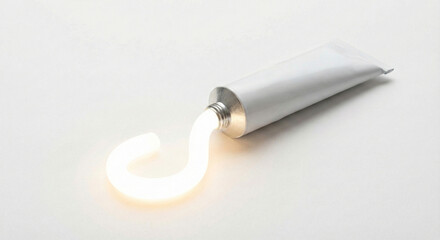 Glowing white toothpaste squeezed out of tube on plain background