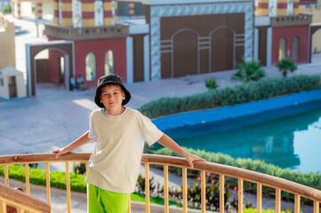 A boy on the beach in a 
 panama hat