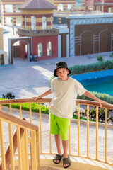 A boy on the beach in a 
 panama hat