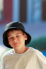 A boy on the beach in a 
 panama hat
